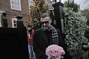 In this Friday, Dec. 23, 2011 file photo, British singer George Michael leaves his house in north London, after recovering from a life-threatening bout with pneumonia that kept him in a Vienna hospital for a month.