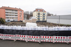 Sand bags and a fence are securing the location of the bomb site next to a construction site in Augsburg, Germany, Sunday Dec. 25, 2016.