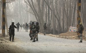 Indian soldiers block a road near the site of a gun battle at Arwani, 55 kilometres (34 miles) south of Srinagar, Indian-controlled Kashmir, Thursday, Dec. 8, 2016. Dozens of civilians in Indian-controlled Kashmir were injured on Thursday as anti-India clashes erupted in the disputed region following a gun battle between rebels and government forces, officials and witnesses said.