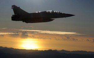 A Taiwan air force jet escorts a plane out of Taiwan airspace carrying Taiwan's President Ma Ying-jeou from Taiwan to Singapore for a meeting with China's President Xi Jinping, Saturday, Nov. 7, 2015.