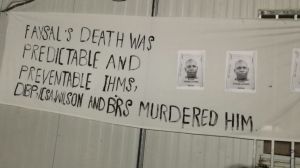 A sign at a memorial service for Faysal Ahmed on Manus Island.