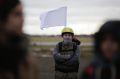 A demonstrator waits for the start of the Civil March for Aleppo demanding help for the people of Syria at the air field ...