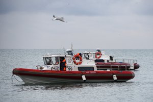 Ministry of Emergency Situations employees search for bodies by a boat in the waters in the Black Sea, off Sochi, Russia, Monday, Dec. 26, 2016.