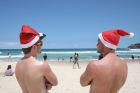 SYDNEY, AUSTRALIA - DECEMBER 23: UK tourists, Nick Ward and Alistair Comlay check out the best spots on Bondi Beach for ...