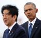 Barack Obama listens as Japanese Prime Minister Shinzo Abe speaks on Kilo Pier in Joint Base Pearl Harbour-Hickam, Hawaii.