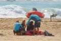 NSW Surf Lifeguards and Surf Rescue assist the mother of the missing boy at Maroubra Beach.