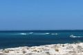 Two boats rush out to pick up surfers after a 2.5 metre shark was spotted 200 metres from shore. 