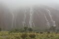 Uluru turns into a cascade of waterfalls as the heavens open up.