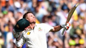 Flying high: David Warner celebrates his century.