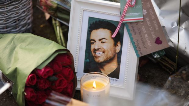 A photograph and floral tributes are left outside the Oxfordshire home of the singer.