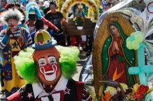 Clowns carry images of the Virgin of Guadalupe during a procession to the Basilica of Guadalupe in Mexico City, ...