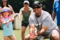 The Roberts family playing cricket in their annual boxing day tradition at Kingston Oval.