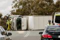 The truck tipped on its side, causing a closure for the Monaro Highway exit onto Old Cooma Road, Royalla.