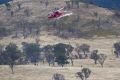 A grass fire at Cooleman Ridge near Kambah is brought undercontrol on Wednesday afternoon. The helicopter leaves the scene.