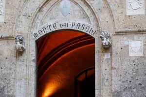 Engraved lettering sits above the entrance to the Banca Monte dei Paschi di Siena SpA headquarters in Siena, Italy.