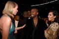 In happier times: Kim Kardashian West, husband Kanye West and Taylor Swift at the 2015 Grammy Awards.