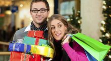 Couple with Christmas presents and bags in shopping mall christmas shopping generic