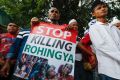 A Rohingya holds a banner during protest after Friday prayers outside the Myanmar embassy in Kuala Lumpur, Malaysia,  in ...