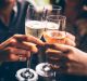 Three female friends celebrating with champagne. They are sitting in a bar and toasting with glasses of champagne. ...