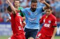 On the run: Alex Brosque tears through the Adelaide United defence on Boxing Day.