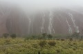 Uluru turns into a cascade of waterfalls as the heavens open up.