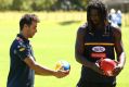 Formula One ace Daniel Ricciardo and ruckman Nic Naitanui in earnest discussion during West Coast Eagles training on ...