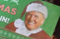 A supporter of President-elect Donald Trump holds up a Christmas-themed sign at a rally in Orlando, Florida.