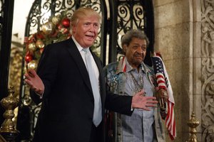 President-elect Donald Trump, left, stands with boxing promoter Don King as he speaks to reporters at Mar-a-Lago, Wednesday, Dec. 28, 2016, in Palm Beach, Fla.