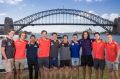 The top 10 picks pose in front of the Sydney Harbour Bridge on Saturday morning.