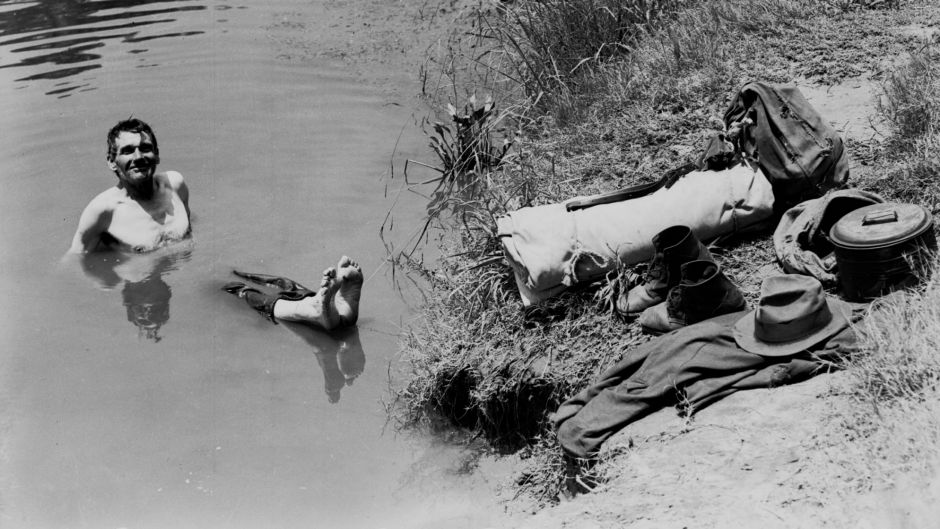 A swagman takes a refreshing dip in the Nepean River in Camden, NSW, during the heatwave of 1938-1939, 10 January 1939. ...