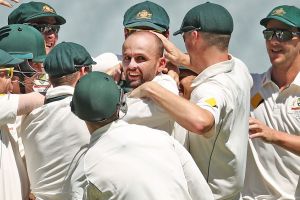 Man in the middle: Nathan Lyon is congratulated after dismissing Asad Shafiq. 