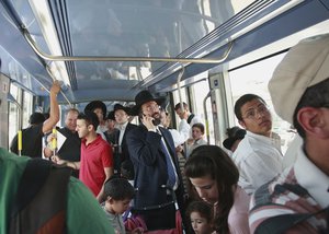 Passengers ride a light rail train on the first day it opened to the public in Jerusalem, Friday, Aug. 19, 2011.