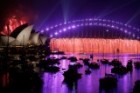 Fireworks explode over the Sydney Opera House and Harbour Bridge during an early evening display.