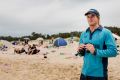 Lifeguard Jackson Maloney, 23, on Broulee Beach on the south coast keeps an eye on conditions on a calm day.