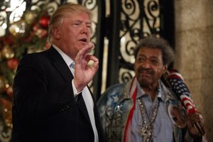 President-elect Donald Trump, left, stands with boxing promoter Don King as he speaks to reporters at Mar-a-Lago, Wednesday, Dec. 28, 2016, in Palm Beach, Fla.