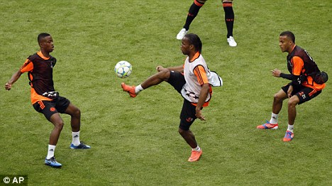 A real handful: Didier Drogba (centre) in training in Munich on Friday