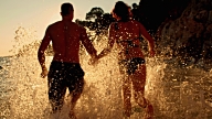 SLO MO Couple Running Into The Sea video