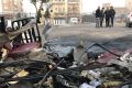 People inspect the aftermath of a car bomb in Baghdad on December 4.