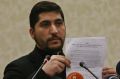 Osama Abu Zeid of the the main moderate Syrian opposition group Free Syrian Army, shows what he said is a copy of the ...