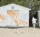 Pam Murphy and her granddaughters Holly and Emily inspect graffiti on their Point King beach box on Sunday