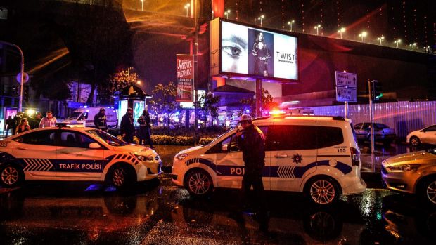 Policemen secure the area after an attack on Reina, a popular night club in Istanbul.