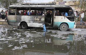 Citizens inspect the scene after a car bomb explosion at a crowded outdoor market in the Iraqi capital's eastern district of Sadr City, Iraq, Monday, Jan 2, 2017.