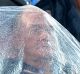 BRISBANE, AUSTRALIA - JANUARY 02: Fans are seen trying to protect themselves from the rain as the match between Steve ...