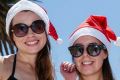 English tourists Megan, Katie and Sammy enjoy the Christmas heat on St.Kilda Beach.