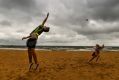 Beachgoers enjoy Williamstown beach despite the cold and gloomy weather.