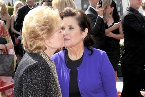 Debbie Reynolds, left, and Carrie Fisher arrive at the Primetime Creative Arts Emmy Awards on Saturday Sept. 10, 2011 in Los Angeles. (AP Photo/Chris Pizzello)