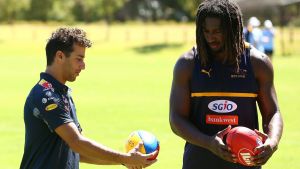 Formula One ace Daniel Ricciardo and ruckman Nic Naitanui in earnest discussion during West Coast Eagles training on ...