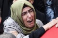 Family and friends of Fatih Cakmak, a security guard killed in the Istanbul nightclub attack, mourn during his funeral ...