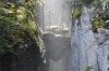 The sunlight streaming through the mists to highlight suspended boulders in the Maligne Canyon, captured the spirit and ...