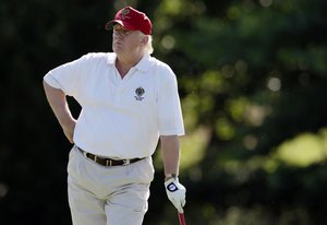 In this June 27, 2012, file photo, Donald Trump stands on the 14th fairway during a pro-am round of the AT&T National golf tournament at Congressional Country Club in Bethesda, Md.